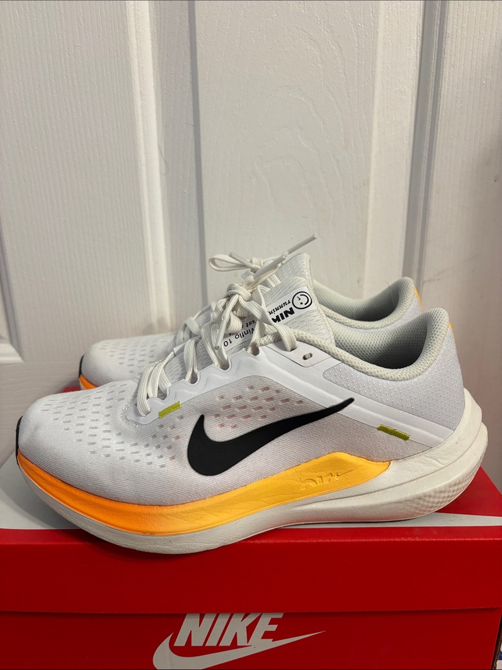 Nike White Running Sneakers with Black Swoosh and Yellow-Orange Midsole